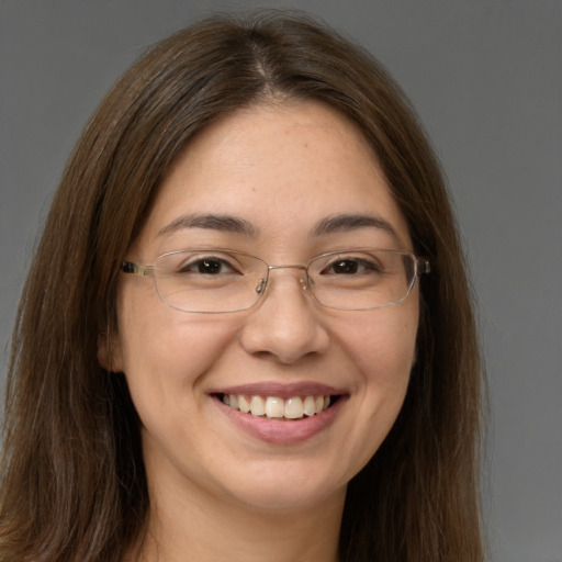 Joyful white adult female with long  brown hair and brown eyes