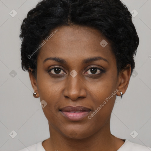 Joyful black young-adult female with short  black hair and brown eyes