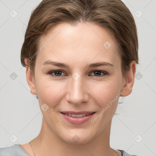 Joyful white young-adult female with short  brown hair and grey eyes