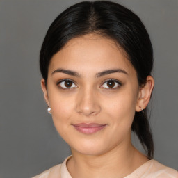 Joyful latino young-adult female with medium  brown hair and brown eyes