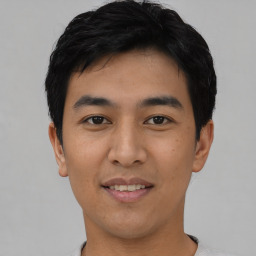 Joyful asian young-adult male with short  black hair and brown eyes