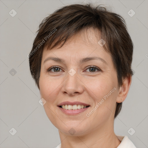 Joyful white adult female with short  brown hair and brown eyes