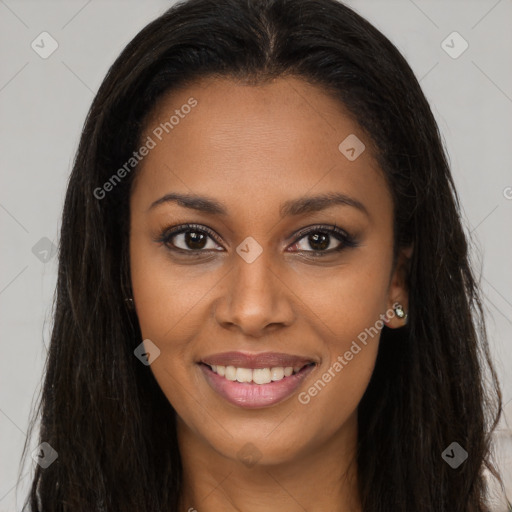 Joyful black young-adult female with long  brown hair and brown eyes