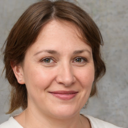 Joyful white adult female with medium  brown hair and brown eyes