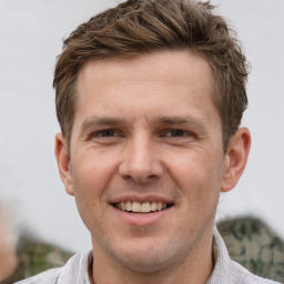 Joyful white adult male with short  brown hair and grey eyes