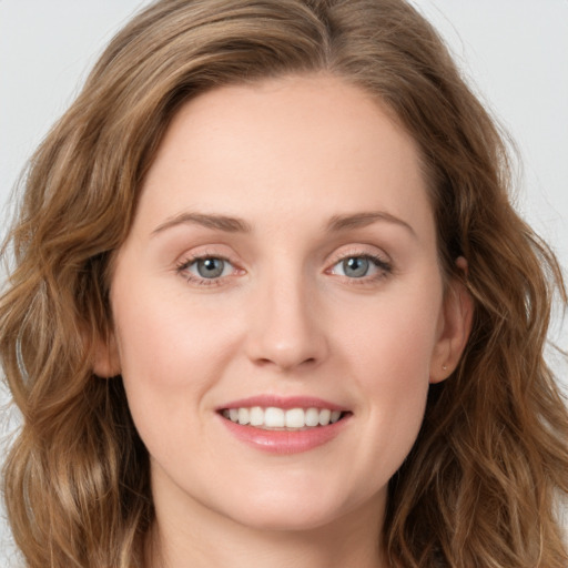 Joyful white young-adult female with long  brown hair and blue eyes