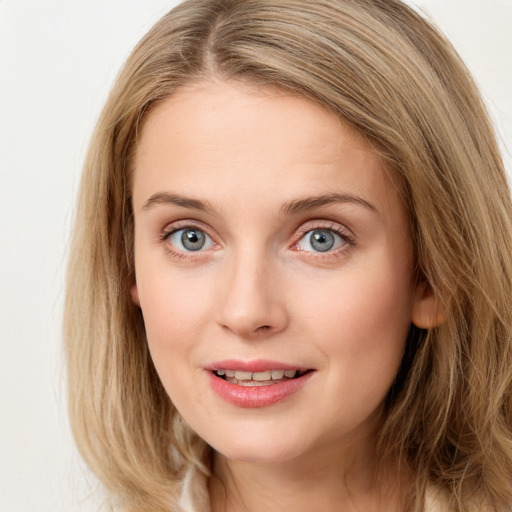 Joyful white young-adult female with long  brown hair and blue eyes