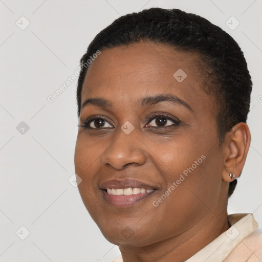 Joyful black young-adult female with short  black hair and brown eyes