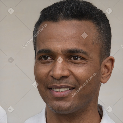 Joyful black young-adult male with short  black hair and brown eyes