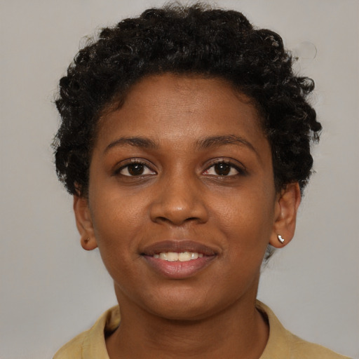 Joyful black young-adult female with short  brown hair and brown eyes