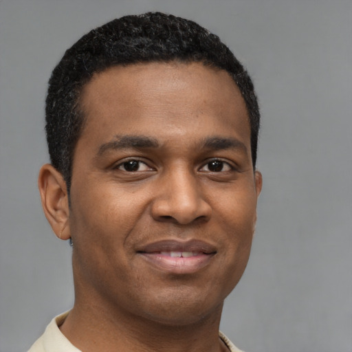Joyful latino young-adult male with short  brown hair and brown eyes