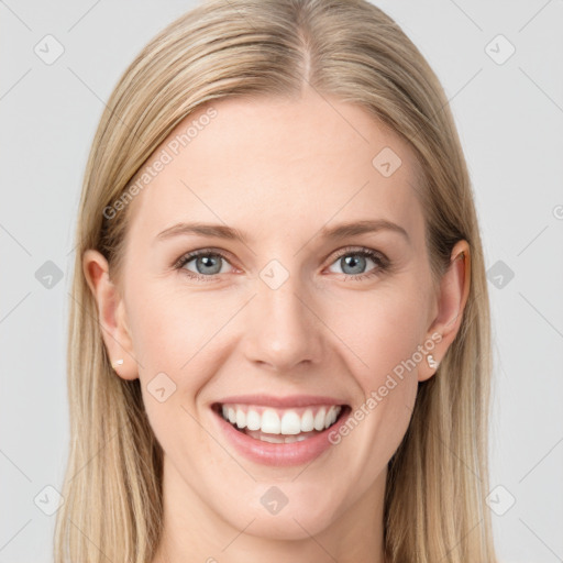 Joyful white young-adult female with long  brown hair and blue eyes