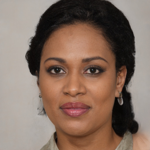 Joyful black adult female with medium  black hair and brown eyes
