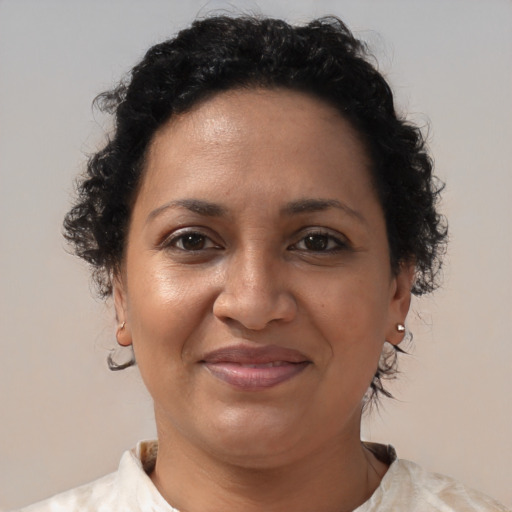 Joyful black adult female with short  brown hair and brown eyes