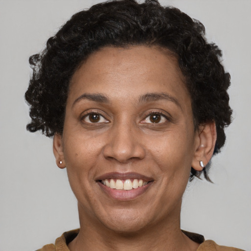 Joyful latino adult female with short  brown hair and brown eyes