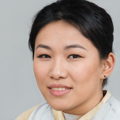 Joyful asian young-adult female with medium  brown hair and brown eyes