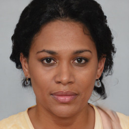 Joyful black adult female with short  brown hair and brown eyes