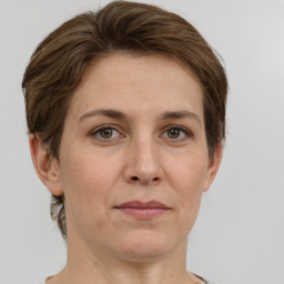 Joyful white adult female with short  brown hair and grey eyes