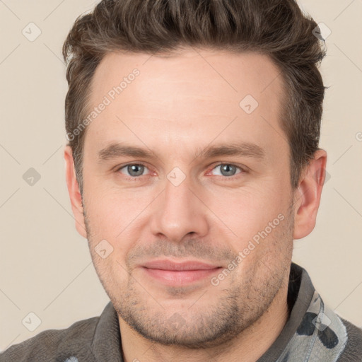 Joyful white young-adult male with short  brown hair and grey eyes