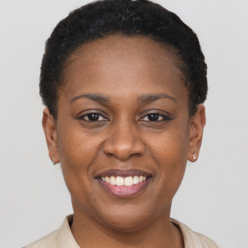 Joyful black young-adult female with short  brown hair and brown eyes
