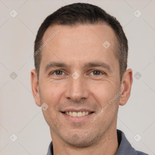 Joyful white adult male with short  brown hair and brown eyes