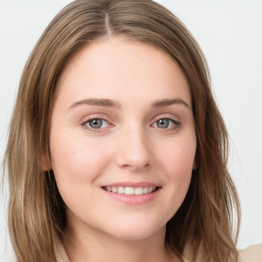 Joyful white young-adult female with long  brown hair and grey eyes