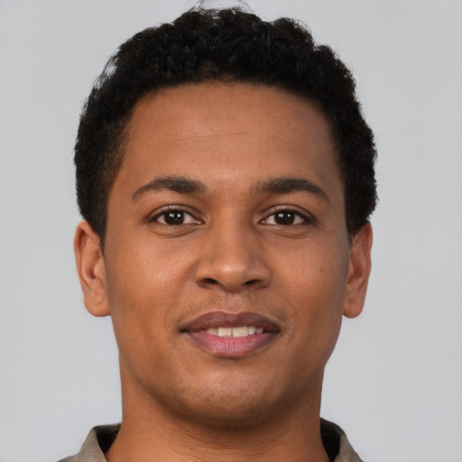 Joyful latino young-adult male with short  brown hair and brown eyes