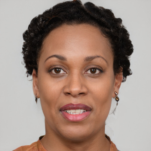 Joyful black adult female with short  brown hair and brown eyes
