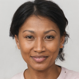 Joyful black adult female with medium  brown hair and brown eyes