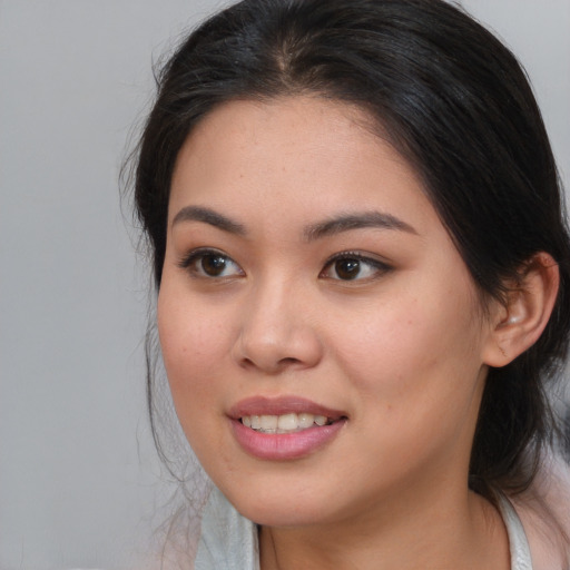 Joyful white young-adult female with medium  brown hair and brown eyes