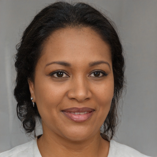 Joyful black young-adult female with medium  brown hair and brown eyes