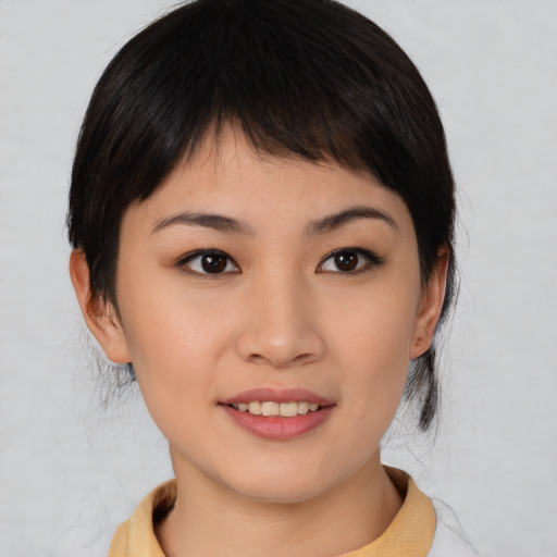Joyful asian young-adult female with medium  brown hair and brown eyes