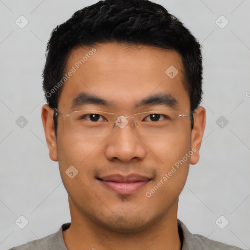 Joyful asian young-adult male with short  black hair and brown eyes