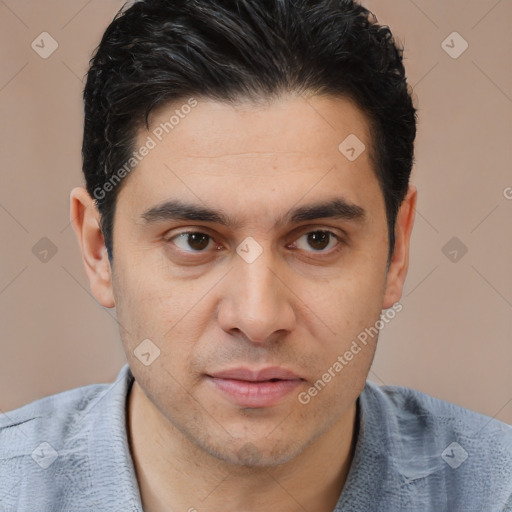 Joyful white young-adult male with short  black hair and brown eyes