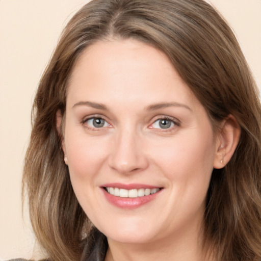 Joyful white adult female with long  brown hair and brown eyes