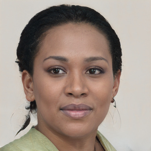 Joyful black young-adult female with short  brown hair and brown eyes