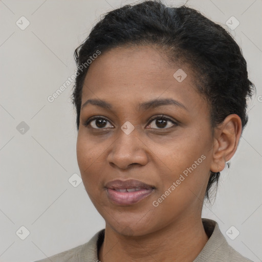 Joyful black young-adult female with short  brown hair and brown eyes