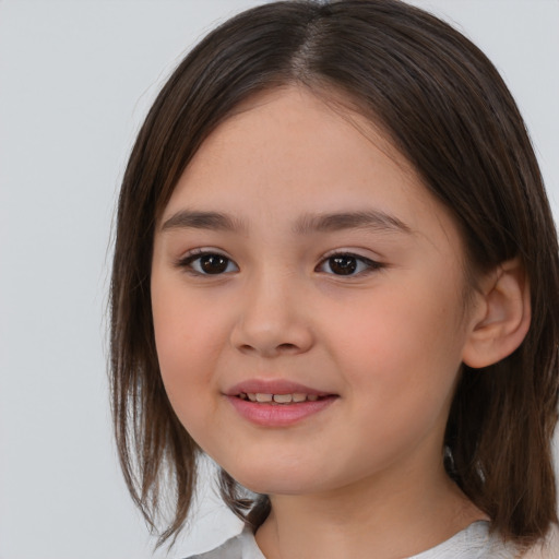 Joyful white child female with medium  brown hair and brown eyes
