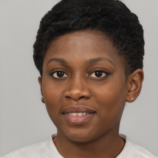 Joyful black young-adult female with short  brown hair and brown eyes