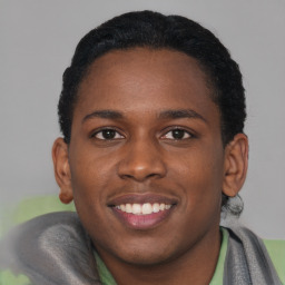 Joyful black young-adult male with short  brown hair and brown eyes