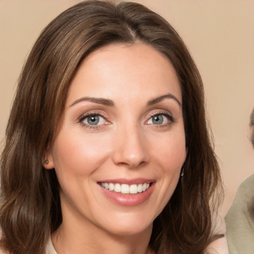 Joyful white young-adult female with medium  brown hair and green eyes