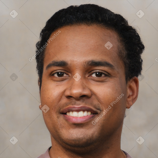 Joyful latino young-adult male with short  brown hair and brown eyes