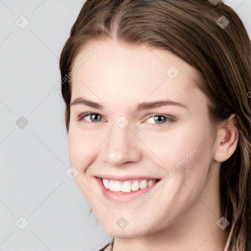 Joyful white young-adult female with long  brown hair and grey eyes