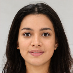 Joyful latino young-adult female with long  brown hair and brown eyes