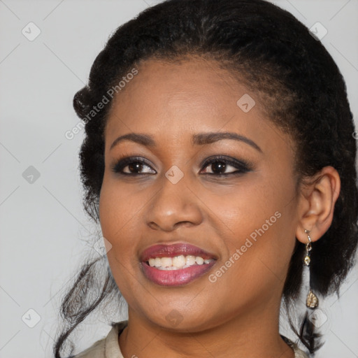 Joyful black young-adult female with long  black hair and brown eyes