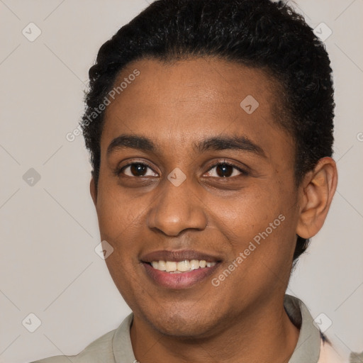 Joyful black young-adult male with short  black hair and brown eyes