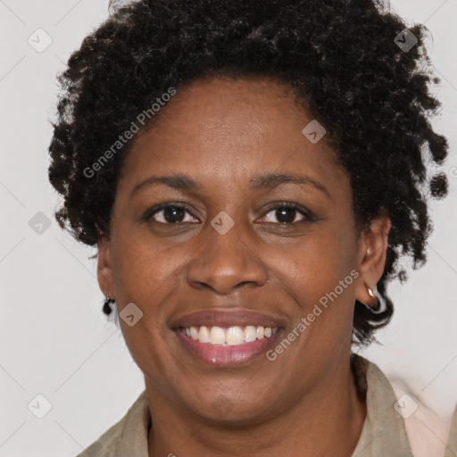 Joyful black adult female with short  brown hair and brown eyes