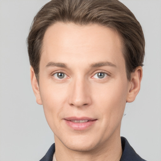 Joyful white young-adult male with short  brown hair and grey eyes