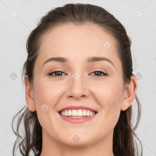 Joyful white young-adult female with long  brown hair and grey eyes