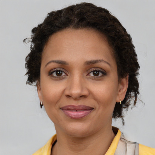 Joyful latino young-adult female with medium  brown hair and brown eyes